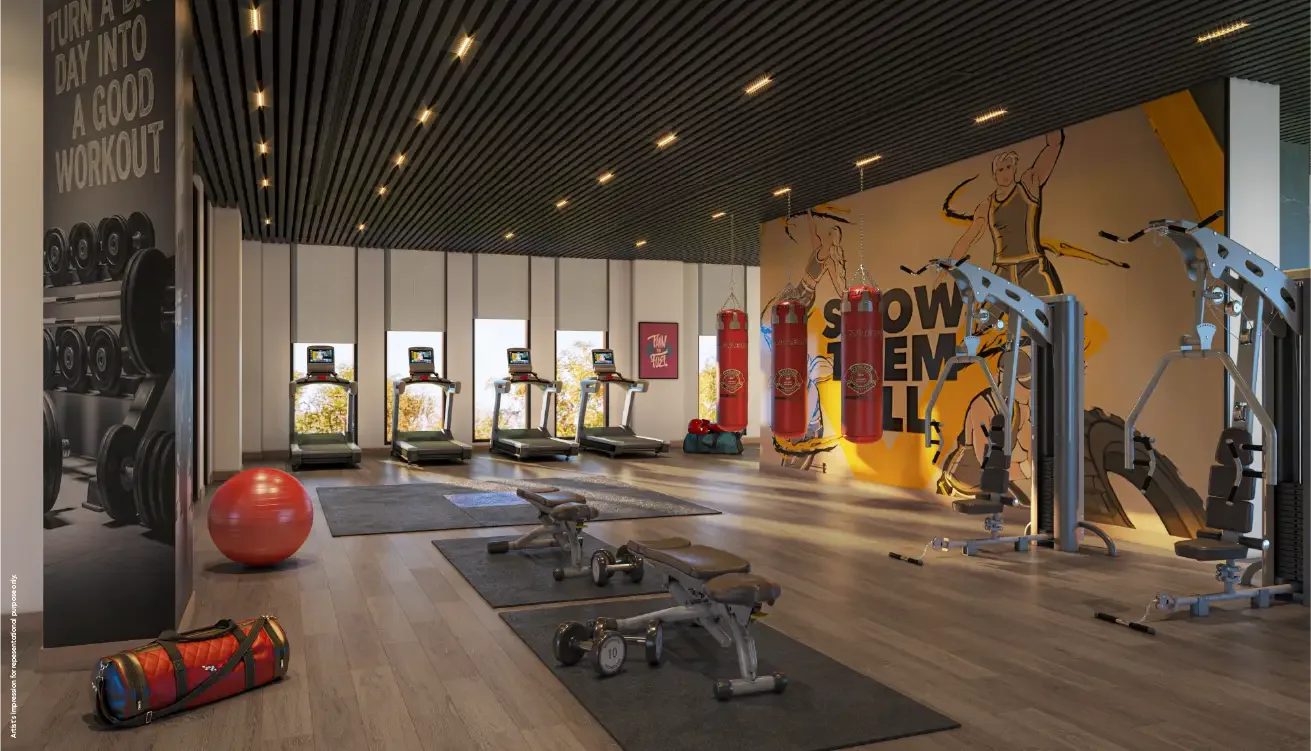 Godrej Elaris gymnasium with cardio equipment and free weights area