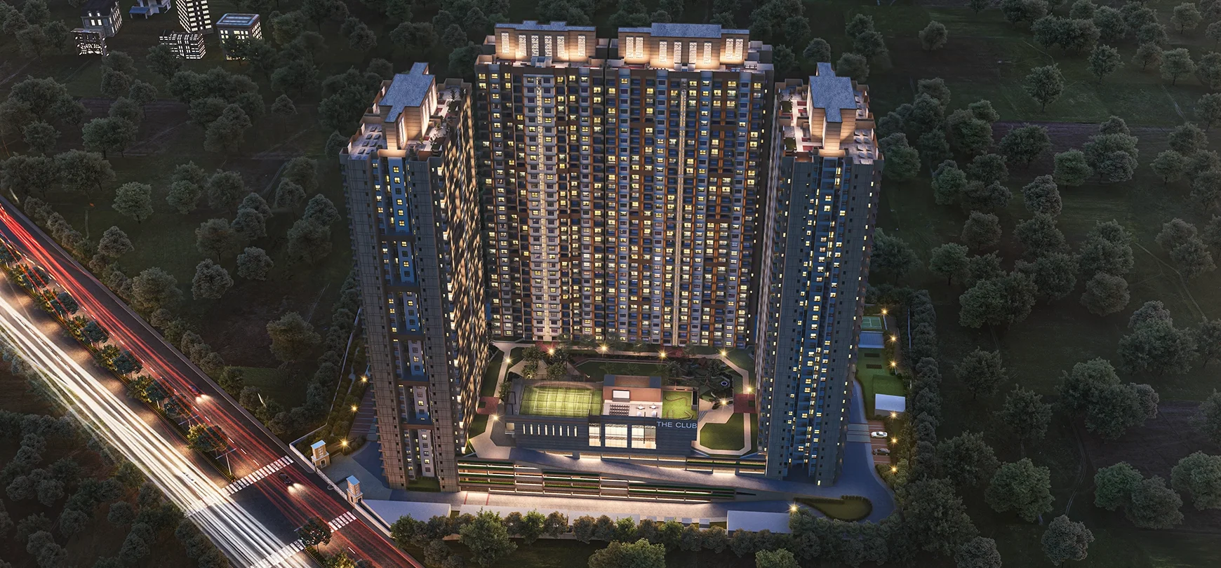 Godrej Woodsville aerial night view of the towers and lit podium